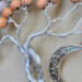 details of twisted aluminum branches rising from a twin tree trunk